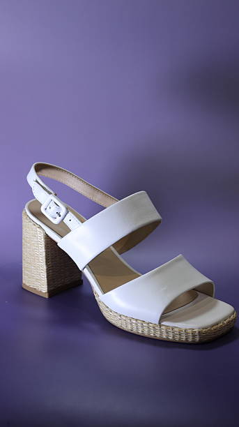 istock white sandals on a purple background 2223557009