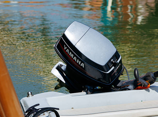 Burano, Italy - June 25, 2025: Yamaha outboard motor is attached to a boat, with shimmering water reflections creating a serene atmosphere
