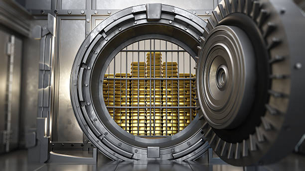 istock Gold bars stacked inside a secure vault with metallic door partially open, showcasing wealth and security in a financial institution 2223557095