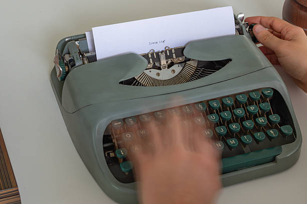istock Writer is typing dream big on vintage typewriter with green keys 2223558982