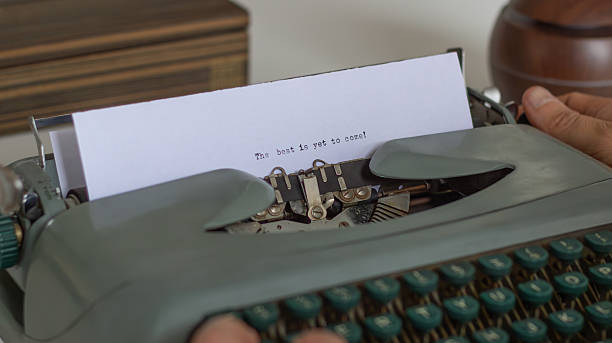 istock Writer using vintage typewriter typing the best is yet to come 2223560231