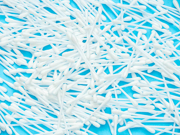 istock White Cotton Swabs Scattered on Blue Background 2223560656