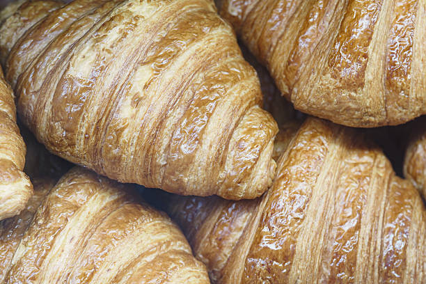 istock Delicious flaky croissants stacked in a bakery display 2223561766
