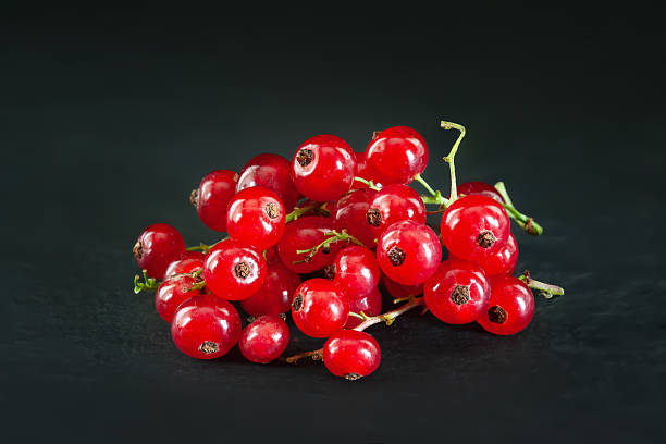 istock Red berries. Red currant. Bunch of red berries on dark background 2223565046