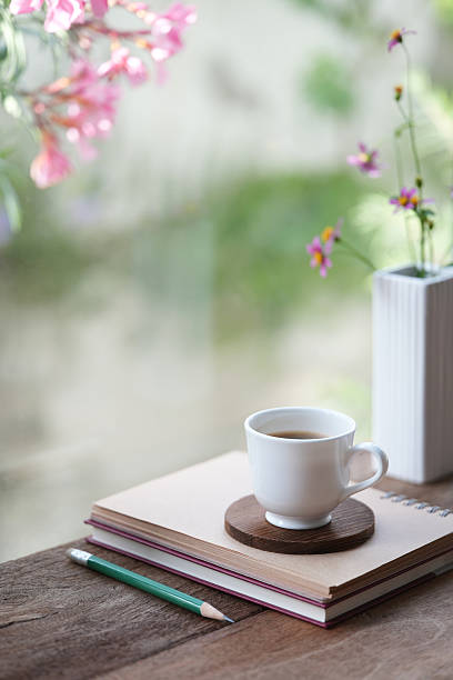istock coffee break and notebook and pink flowers vase 2223567350