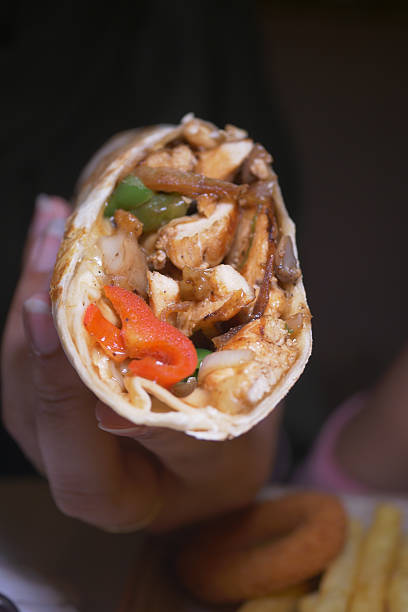 istock Delicious chicken wrap with vibrant vegetables and spices inside 2223568636