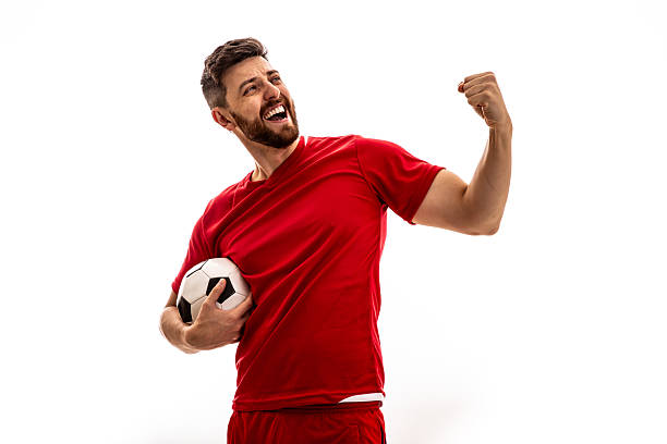 istock Excited soccer player celebrating victory while holding a ball 2223568855