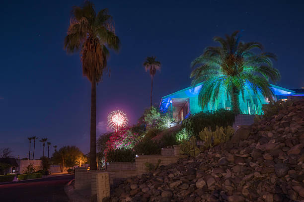 Mid-Century Home on Hillside with Fireworks and Palm Trees at Night