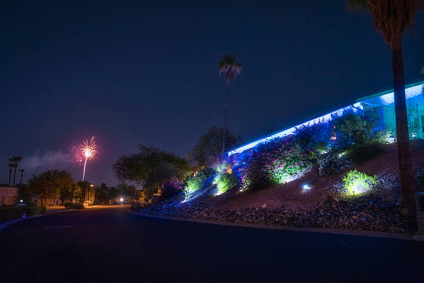 Desert Hillside Home with Fireworks and Colorful Landscape Lighting