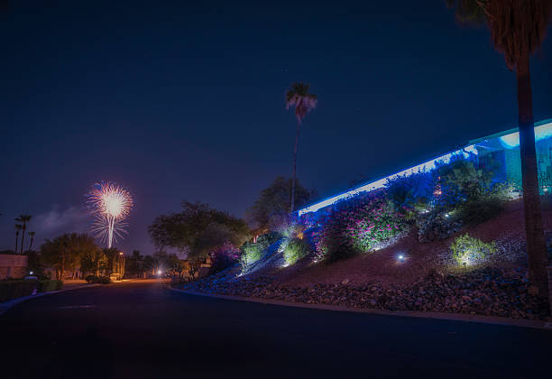 Fireworks Over Mid-Century Hillside Home with Illuminated Landscape