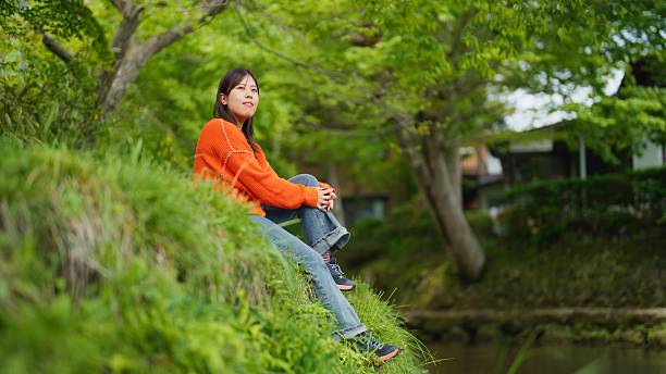 A woman is feeling calm and relaxed in nature.