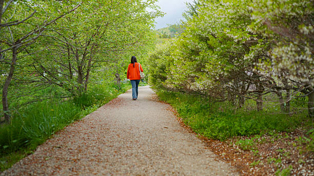 A happy woman tourist is casually walking in nature.