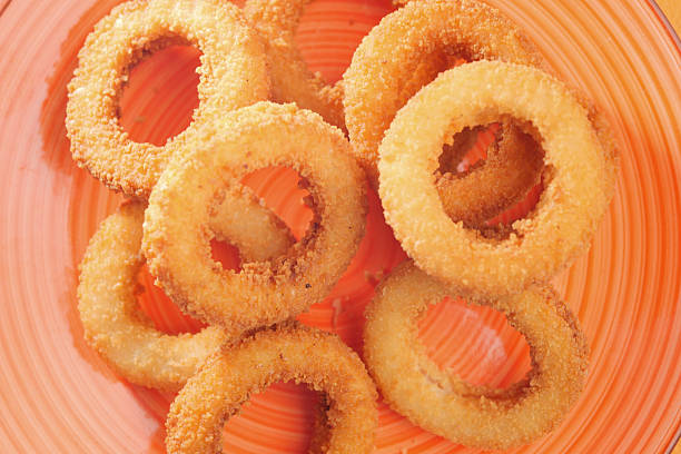 A colorful bowl filled with golden crispy onion rings ready to enjoy.