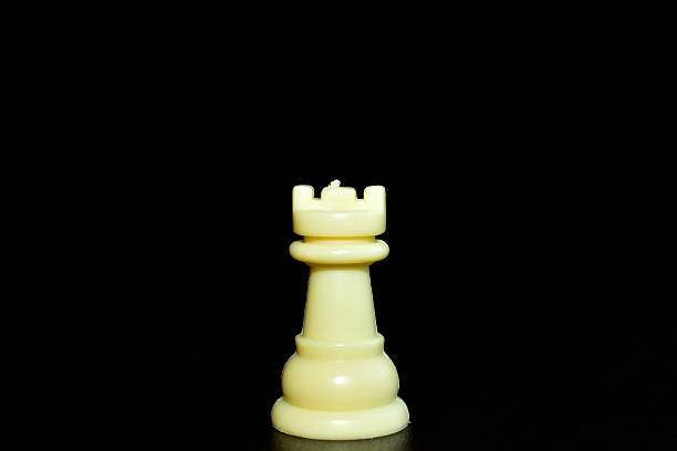 Chess piece of the tour, white on a black background.