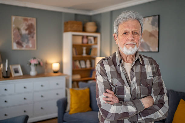 istock Senior man standing in cozy living room 2223577144