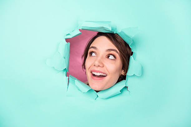 istock Photo of nice optimistic brunette lady look empty space broke wall isolated on bright teal color background 2223577567