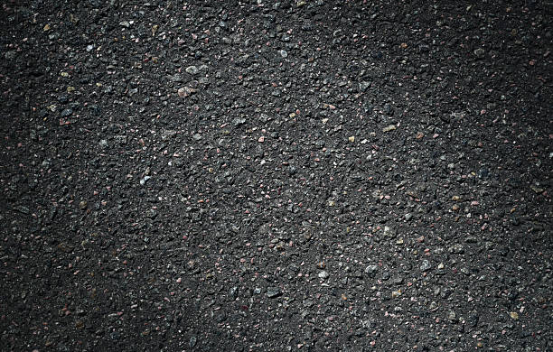 istock Texture of dark, grainy asphalt with uneven texture. 2223577731