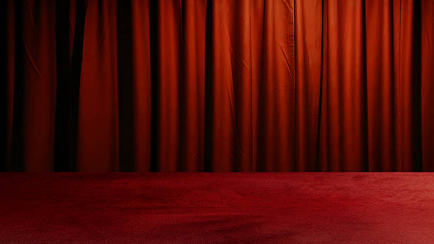 istock red velvet cloth table at foreground with red drape curtains at background. modern background for presents products. template for advertising. 2223578033