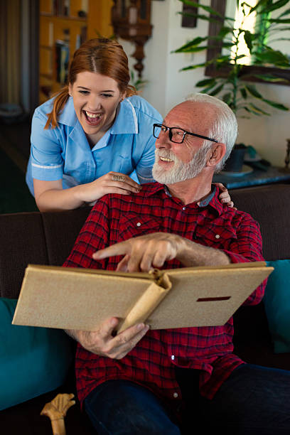 istock Senior man and young nurse talking and bonding 2223578354