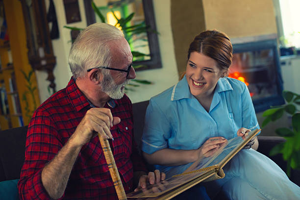 istock Senior man and young nurse talking and bonding 2223578429