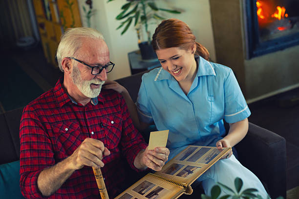 istock Senior man and young nurse talking and bonding 2223578450