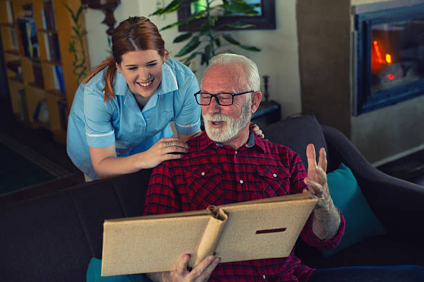 istock Senior man and young nurse talking and bonding 2223578484