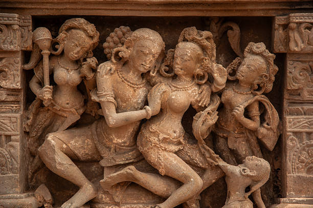 May 31, 2025.  Detailed stone carvings depicting figures in a historic and cultural setting at Chand Baori, India, highlighting ancient craftsmanship and traditional attire