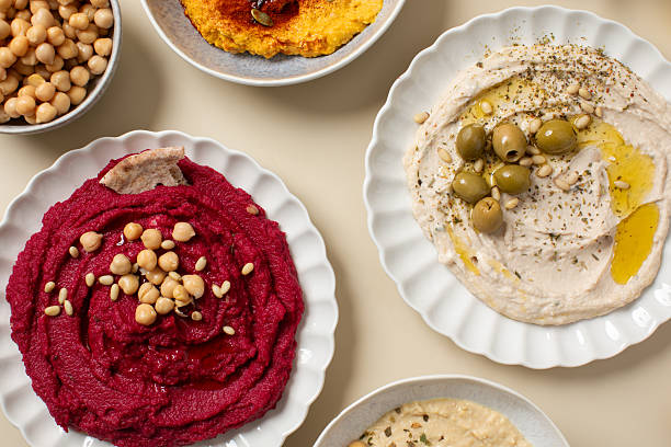 istock Different types of hummus in bowls and plates. Beetroot, pumpkin, chickpea and bean hummus. 2223586561