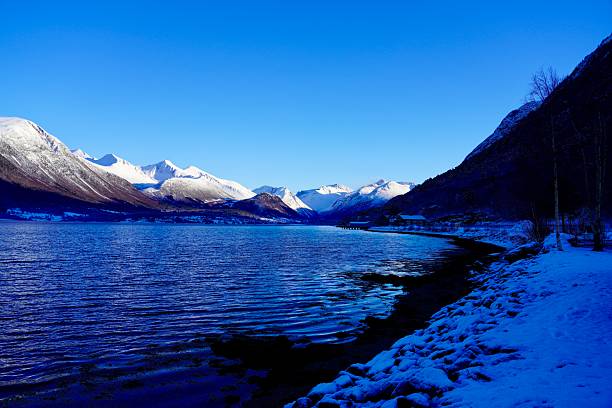 Majestic mountains rising above the isfjorden, near the town of Aandalsnes, Norway.