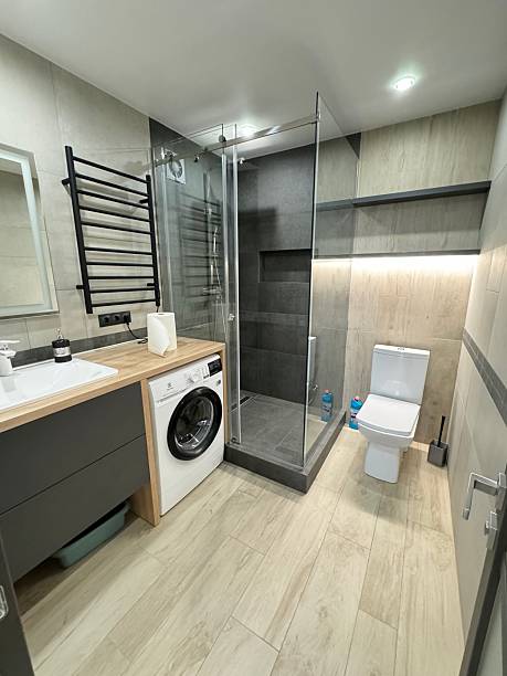 istock Modern Bathroom Interior with Glass Shower and Washing Machine 2223589098