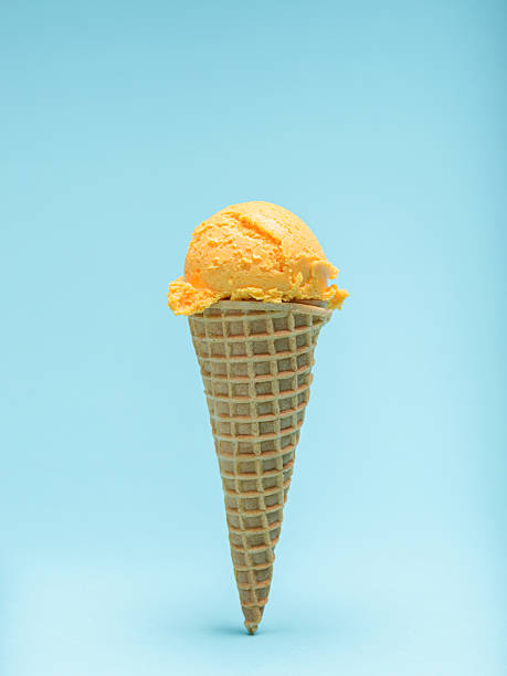 istock Orange ice cream cone isolated on blue background. 2223592823