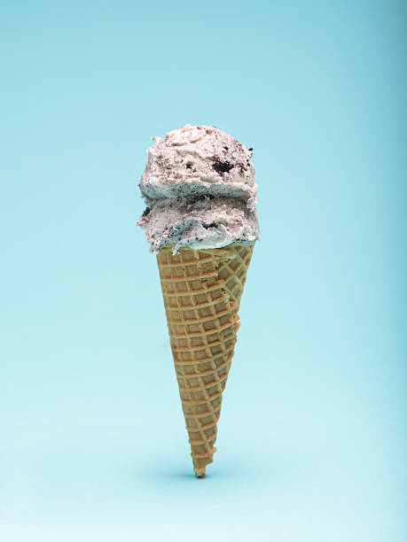 istock Cookies and cream ice cream cone, isolated on a light blue background 2223592846