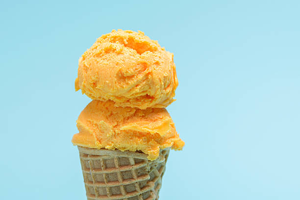 istock Orange ice cream cone isolated on blue background. 2223592853