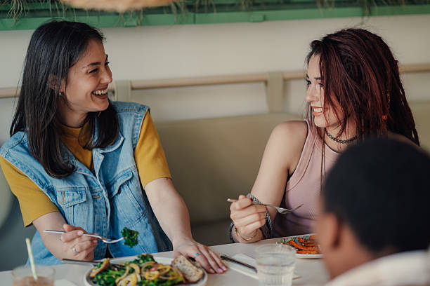 istock Young women having lunch and enjoying conversation at restaurant table 2223594710