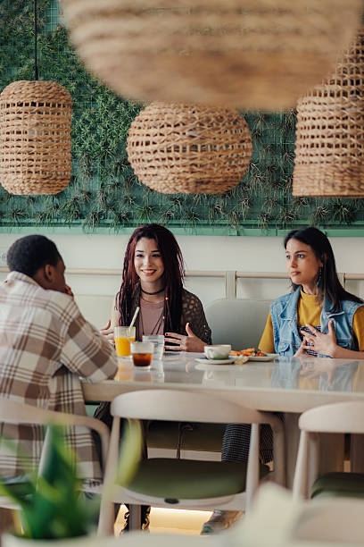 istock Young creatives enjoying a break at the cafe, discussing their next project 2223594781