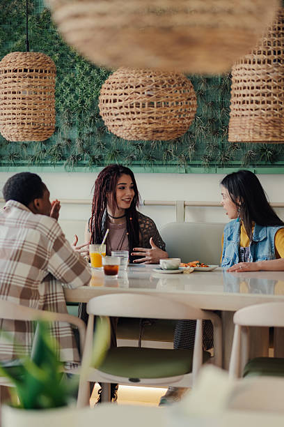 istock Young friends enjoying a meal together at a modern restaurant 2223594782