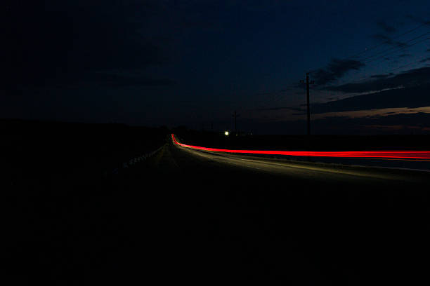 istock A car driving on a road at night 2223594853