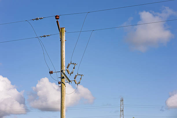 istock Electricity Utility Pole and Power Lines Against Blue Sky 2223603445