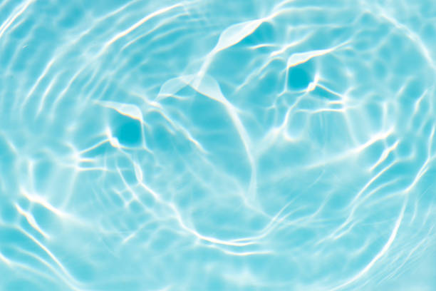 istock Blue water with ripples on the surface. Defocus blurred transparent blue colored clear calm water surface texture with splashes and bubbles. Water waves with shining pattern texture background. 2223605061