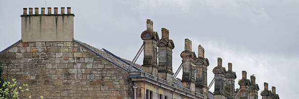 istock Chimney pots in a row on old victorian building roof 2223607696
