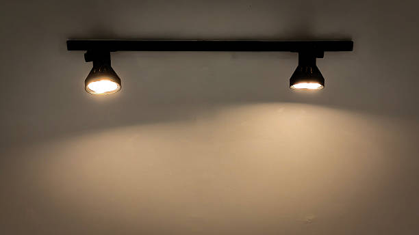 istock Modern dual spotlights mounted on a wall, creating a soft ambient glow. 2223608918