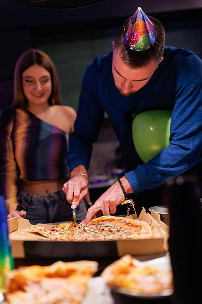 Young adults enjoying a vibrant party sharing pizza
