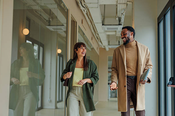 istock Businesspeople walking and talking in office hallway 2223610577