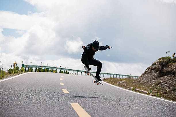istock Skateboarder skateboarding on snowy country road 2223612902