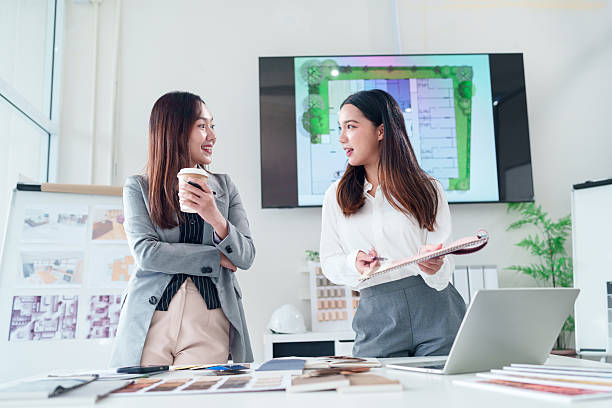 istock Asian Interior Designer Women Discussing Project Details with Blueprint on Screen for Creative Home Design Ideas and Renovation Planning 2223614378