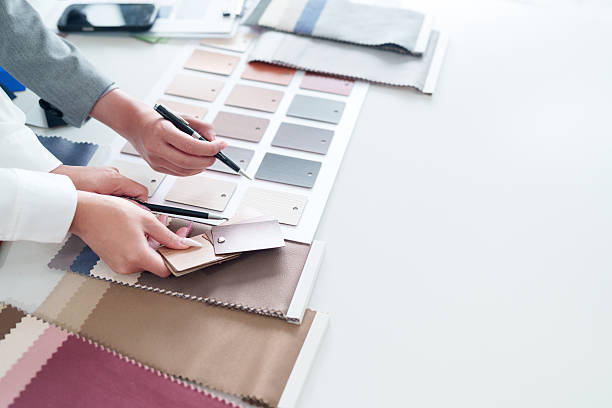 istock Interior Designer Selecting Material Samples for Home Decor Project Asian Hands Choosing Wood Fabric and Color Swatches for Renovation Project Home Design Ideas and Consultation 2223614390