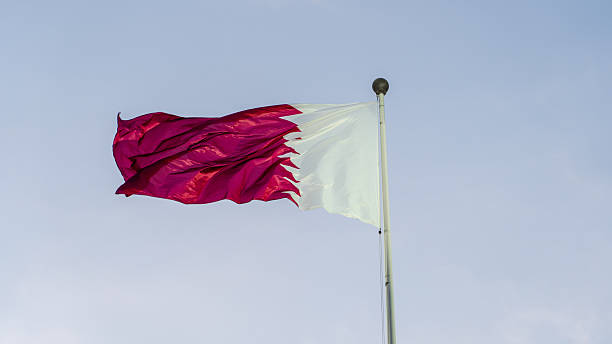istock qatar flag flying high in the wind. 2223621217
