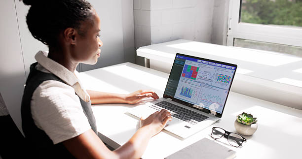 istock Female Business Analyst Reviews KPI Graphs 2223628263