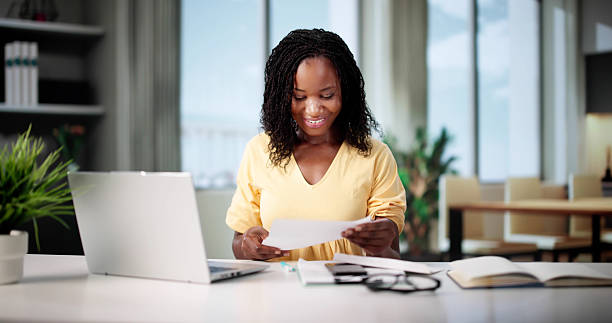 istock Smiling Woman Reading Letter, Reviewing Documents 2223628615