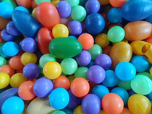 A colorful assortment of plastic balls in various bright hues, typically found in children's play areas or ball pits